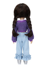 Doll wearing a purple sweater and light blue pants on a white background