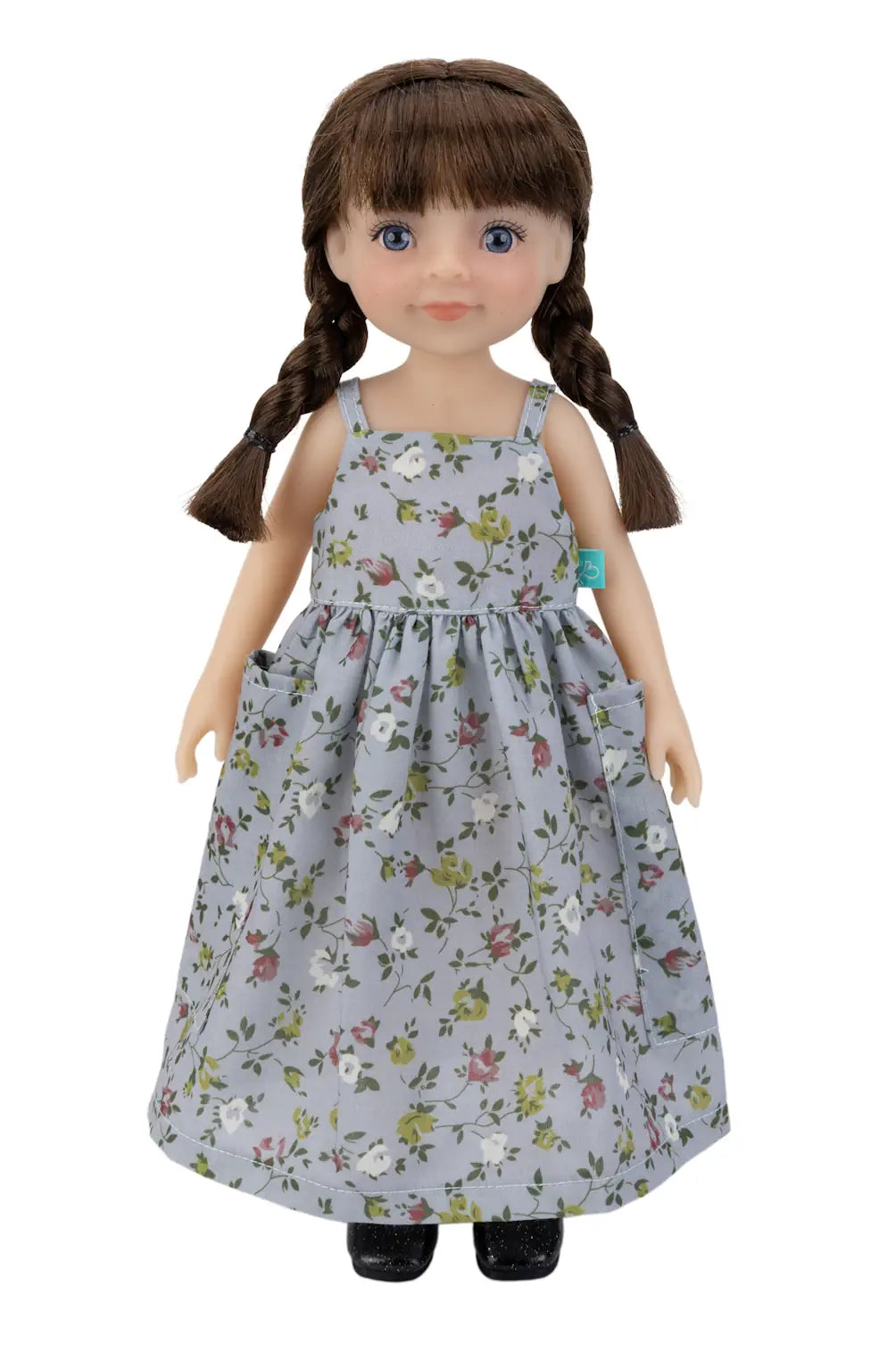 Doll wearing a floral dress on a white background