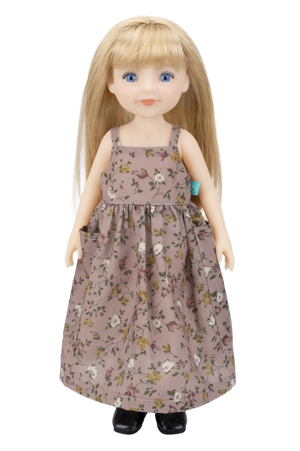 Doll wearing a floral dress on a white background