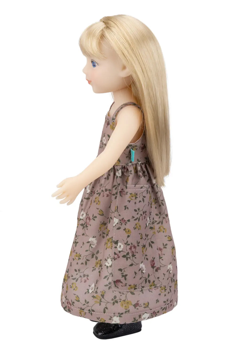 Doll wearing a floral dress on a white background