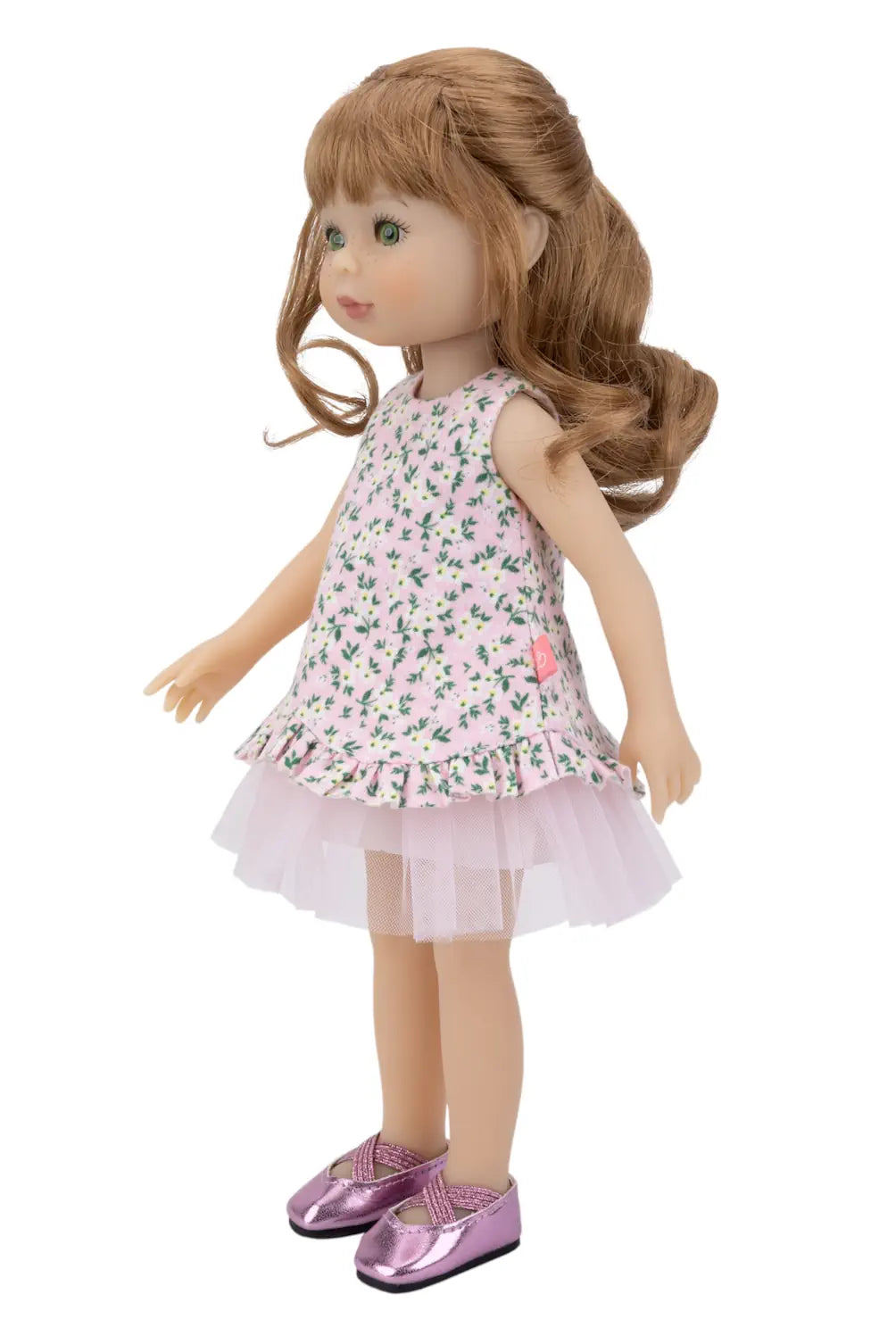 Doll wearing a floral dress with a white background
