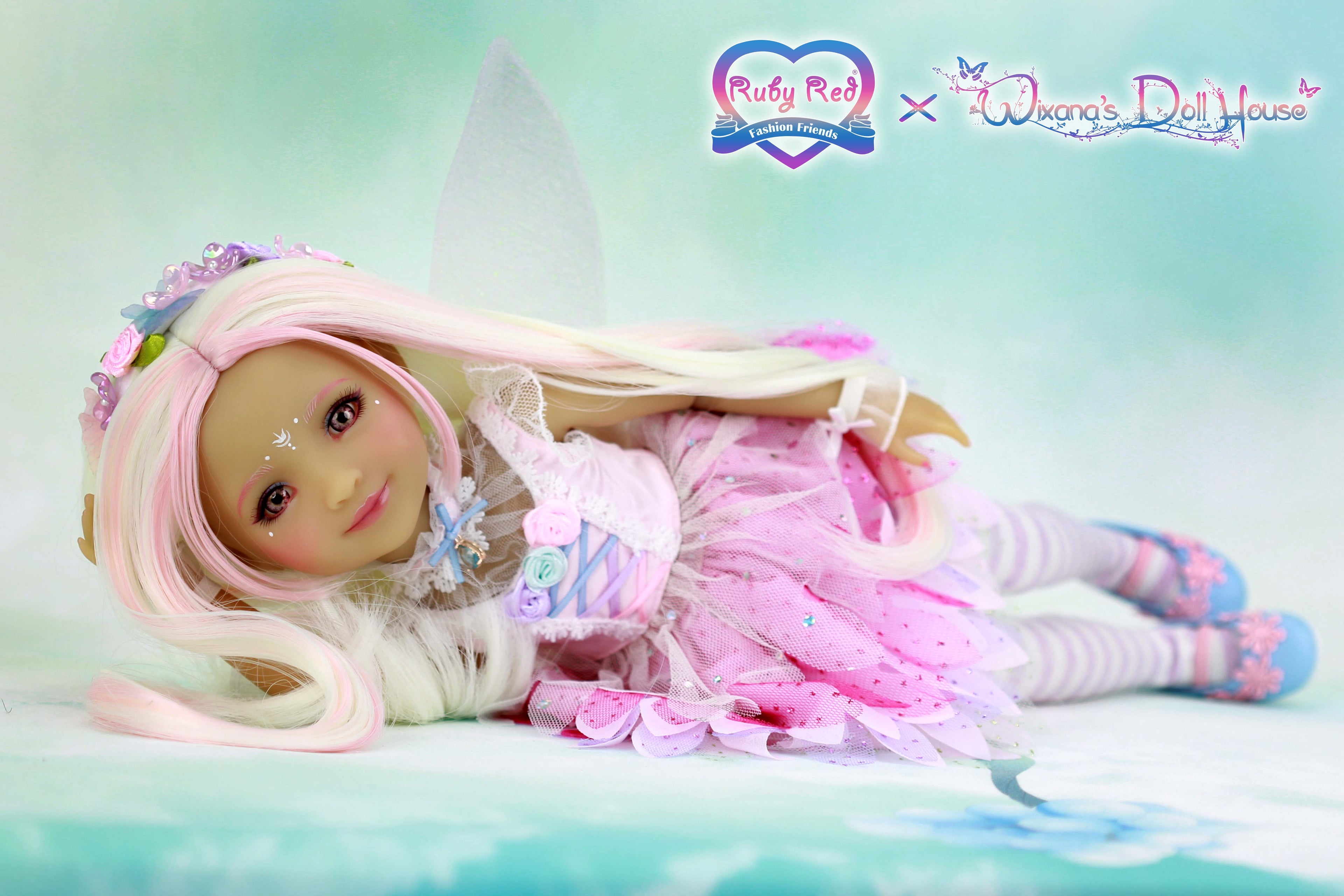 Doll with pastel outfit and accessories on a light blue background