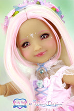 Doll with pink hair and pastel outfit.