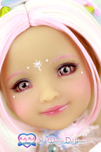 Close-up of a doll with pink hair and accessories, featuring branding logos.