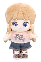 Fluffy Sara plush toy with blonde hair and blue eyes, wearing a white shirt with text and denim shorts.