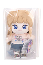 Fluffy Sara plush toy with blue eyes and blonde hair in a clear package