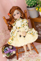 Doll in a floral dress sitting on a wooden chair with a pink background