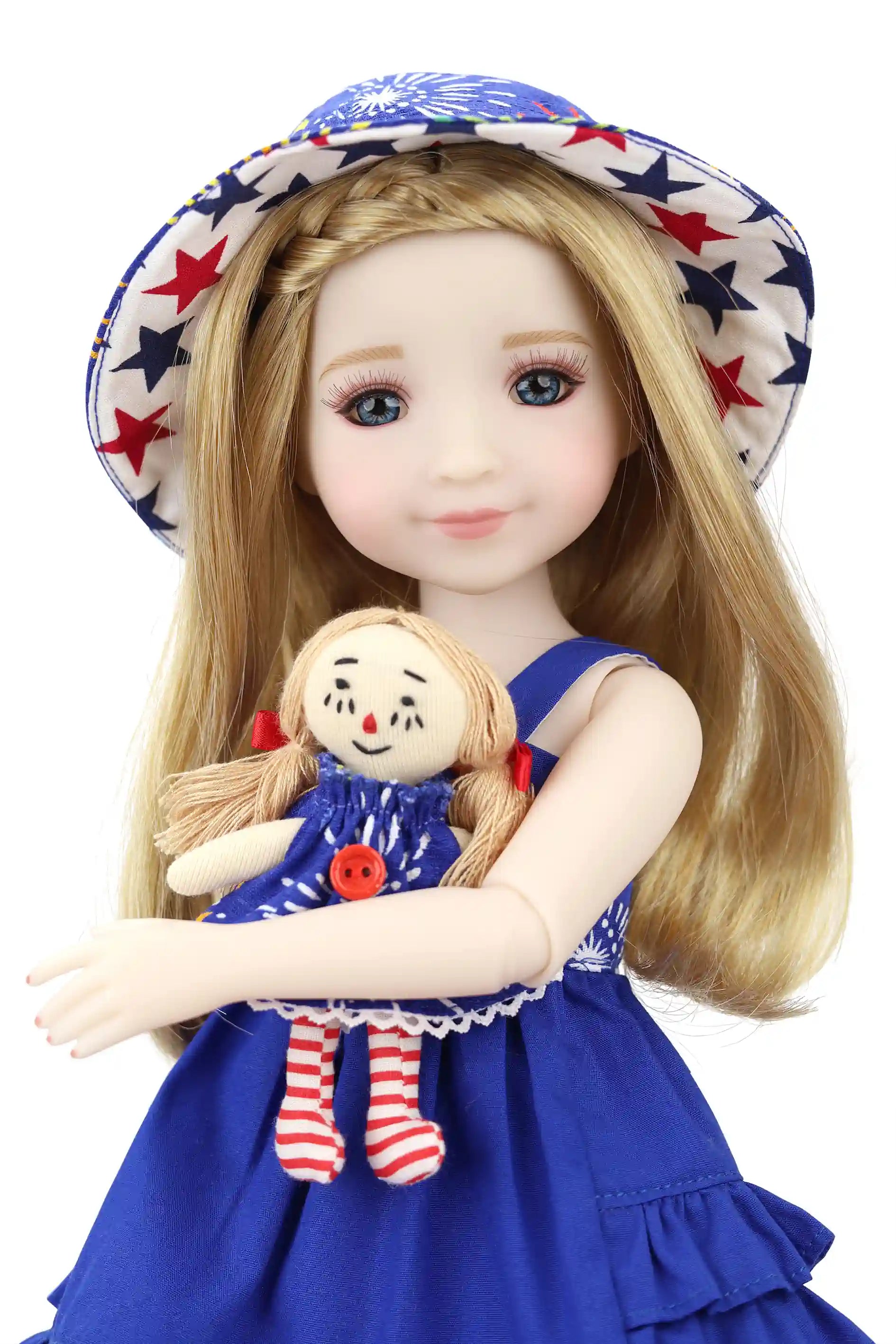 Doll wearing a blue dress with a star-patterned hat holding a smaller doll.