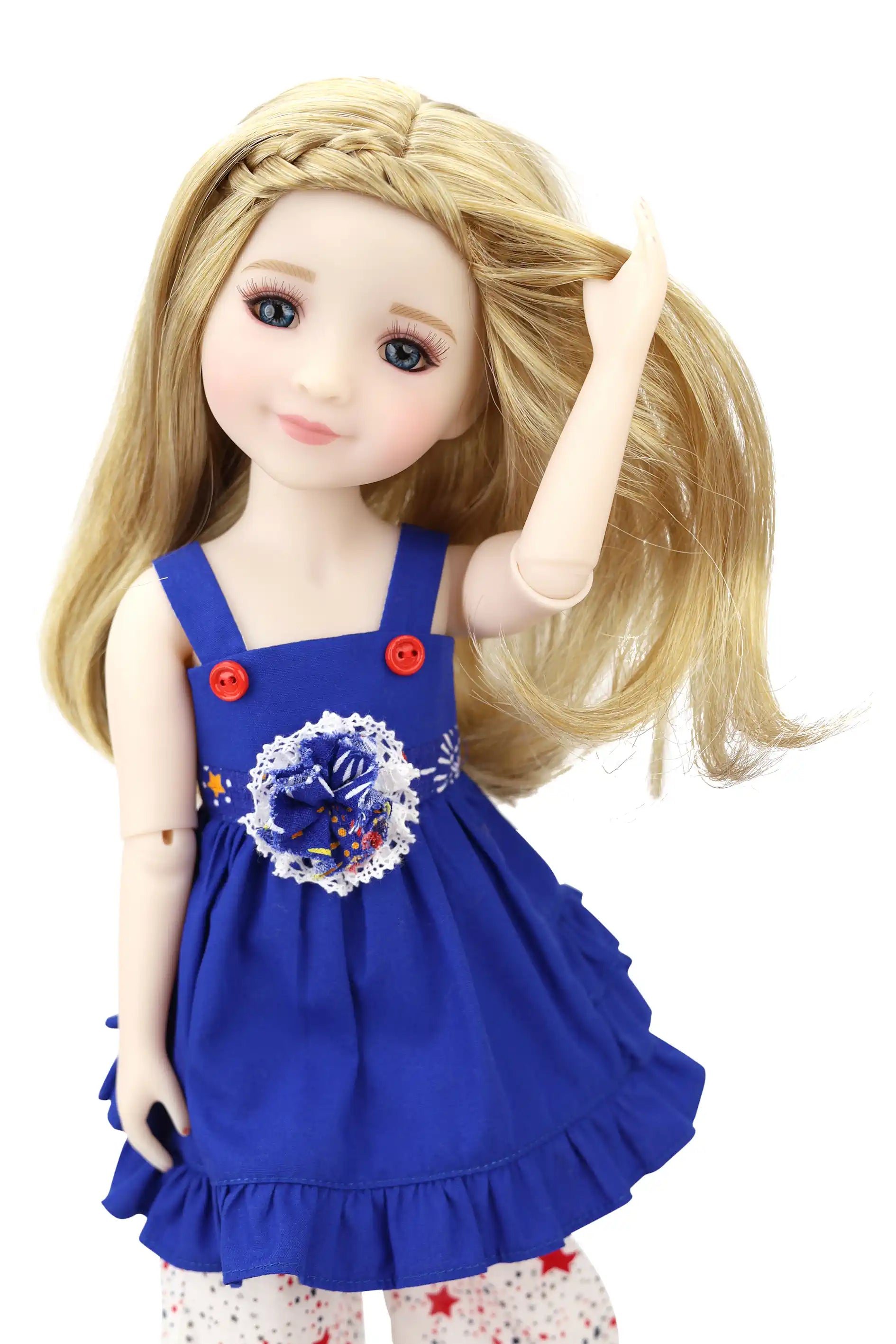 Doll wearing a blue dress with a floral design on a white background
