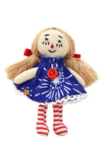 Toy doll with blonde hair, blue dress with a red button, and red and white striped socks on a white background.