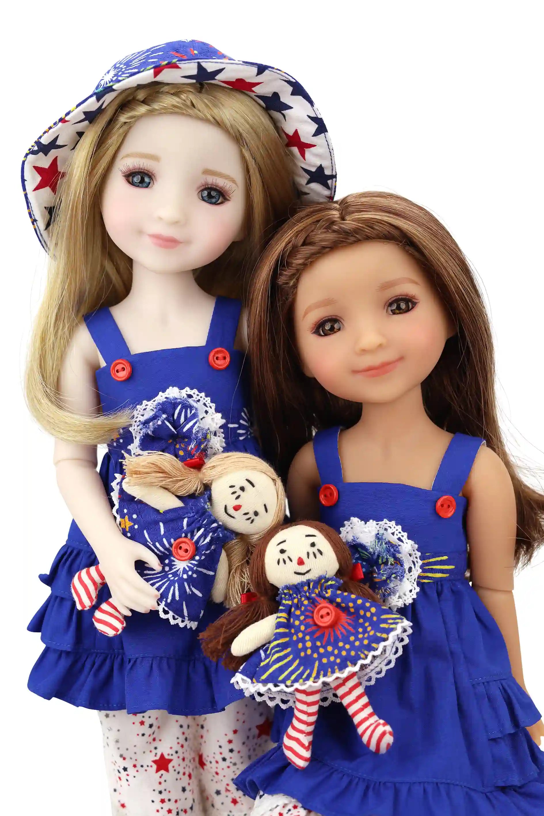 Two dolls in matching blue outfits with red buttons, holding small dolls, on a white background.