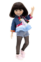 Hanna wearing a denim outfit with a white background