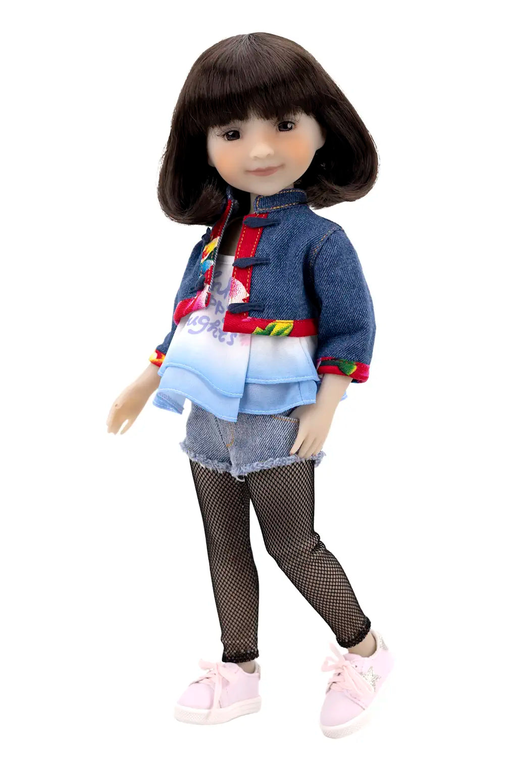 Doll wearing a colorful outfit with a denim jacket and pink shoes on a white background