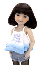 Doll wearing a white tank top with text and denim shorts on a white background