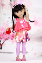 Doll wearing a pink outfit with a cherry blossom background