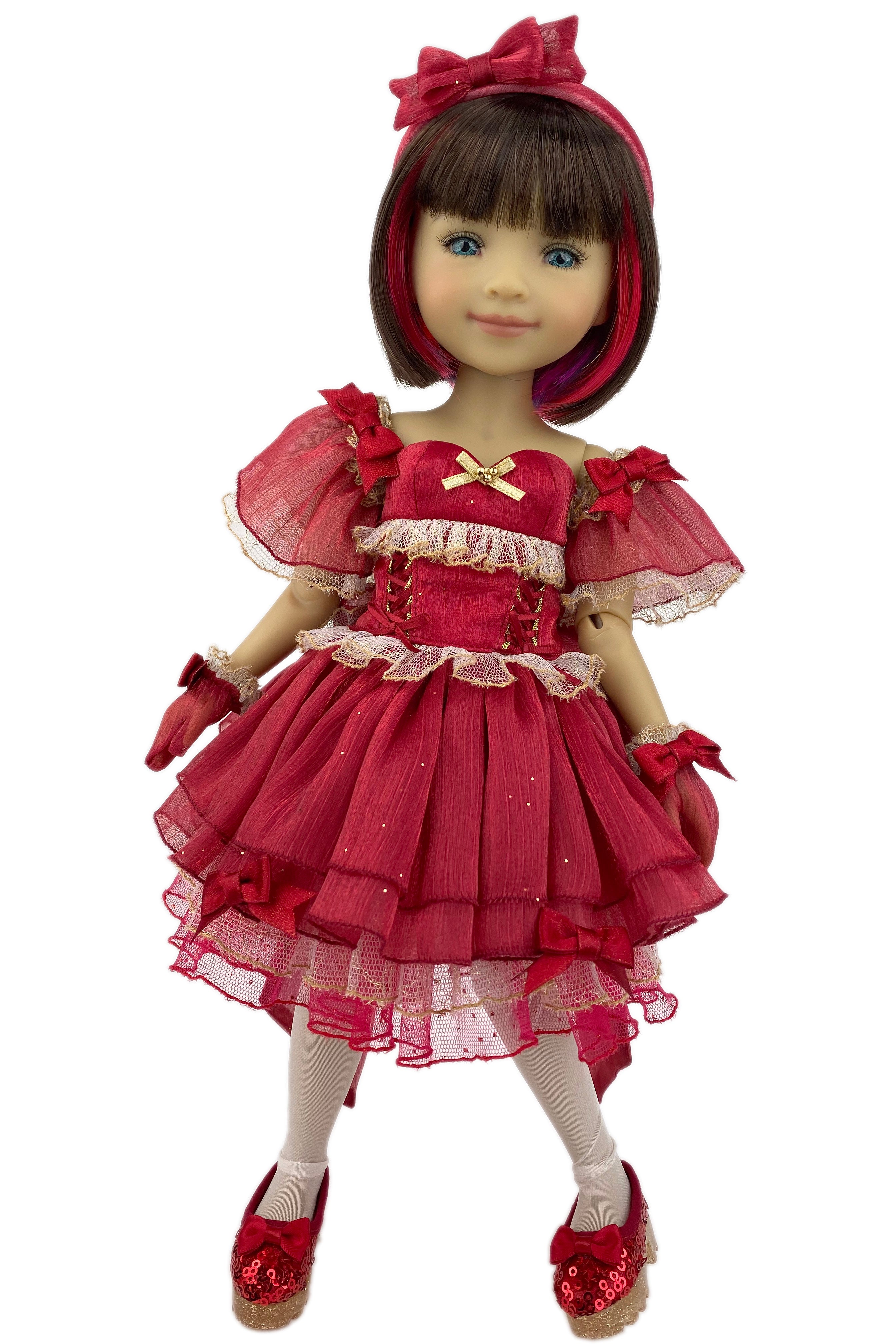 Doll in a red dress with a bow on a white background