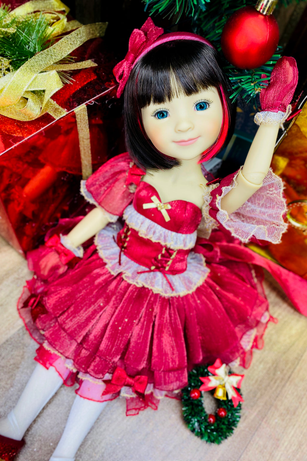 Christmas-themed doll in a red dress with decorative elements on a festive background