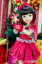 Doll in a red dress with a wreath, surrounded by festive decorations