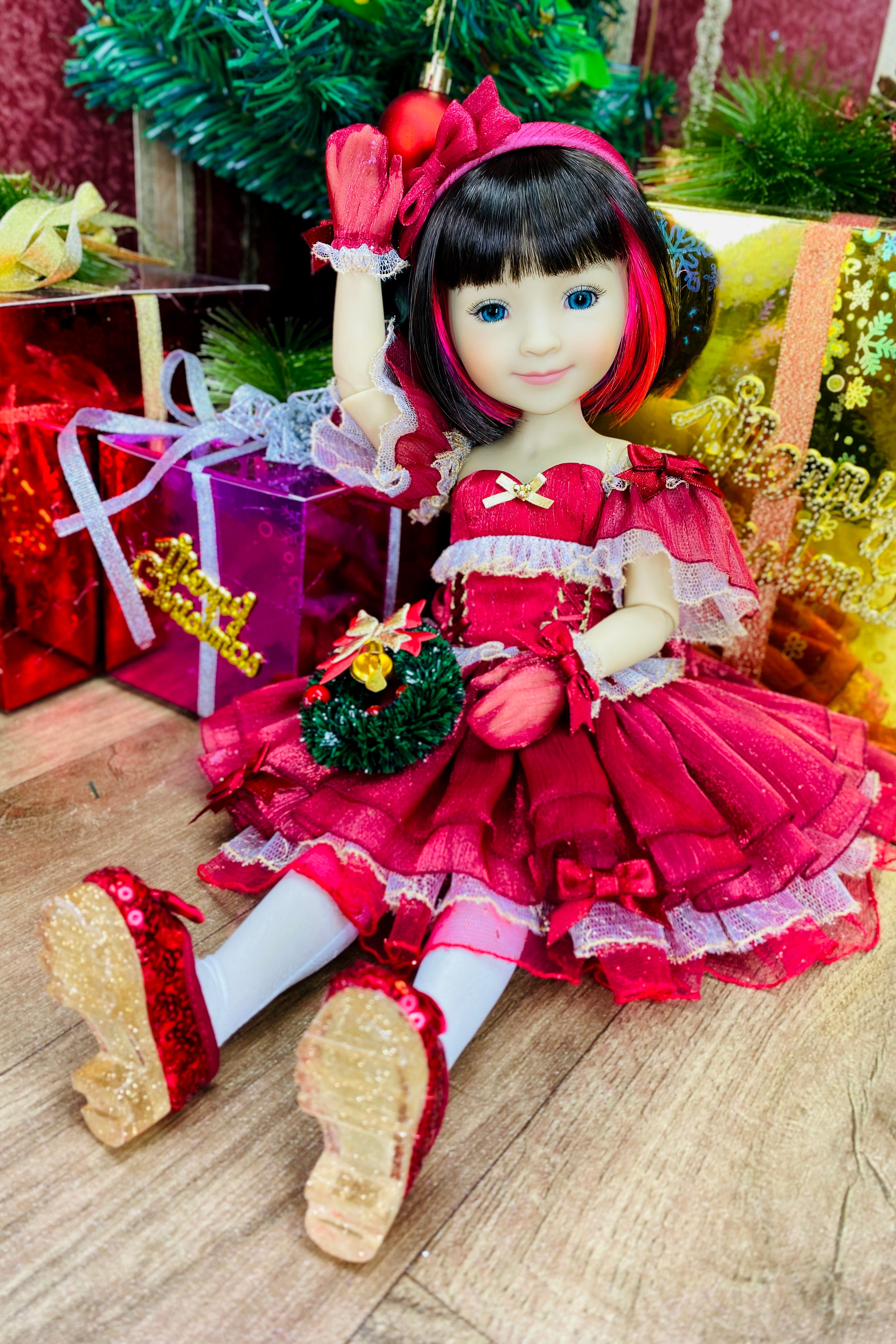 Doll in a red dress with Christmas decorations and presents in the background