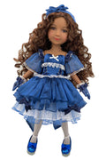 Doll in a blue dress with white accents on a white background