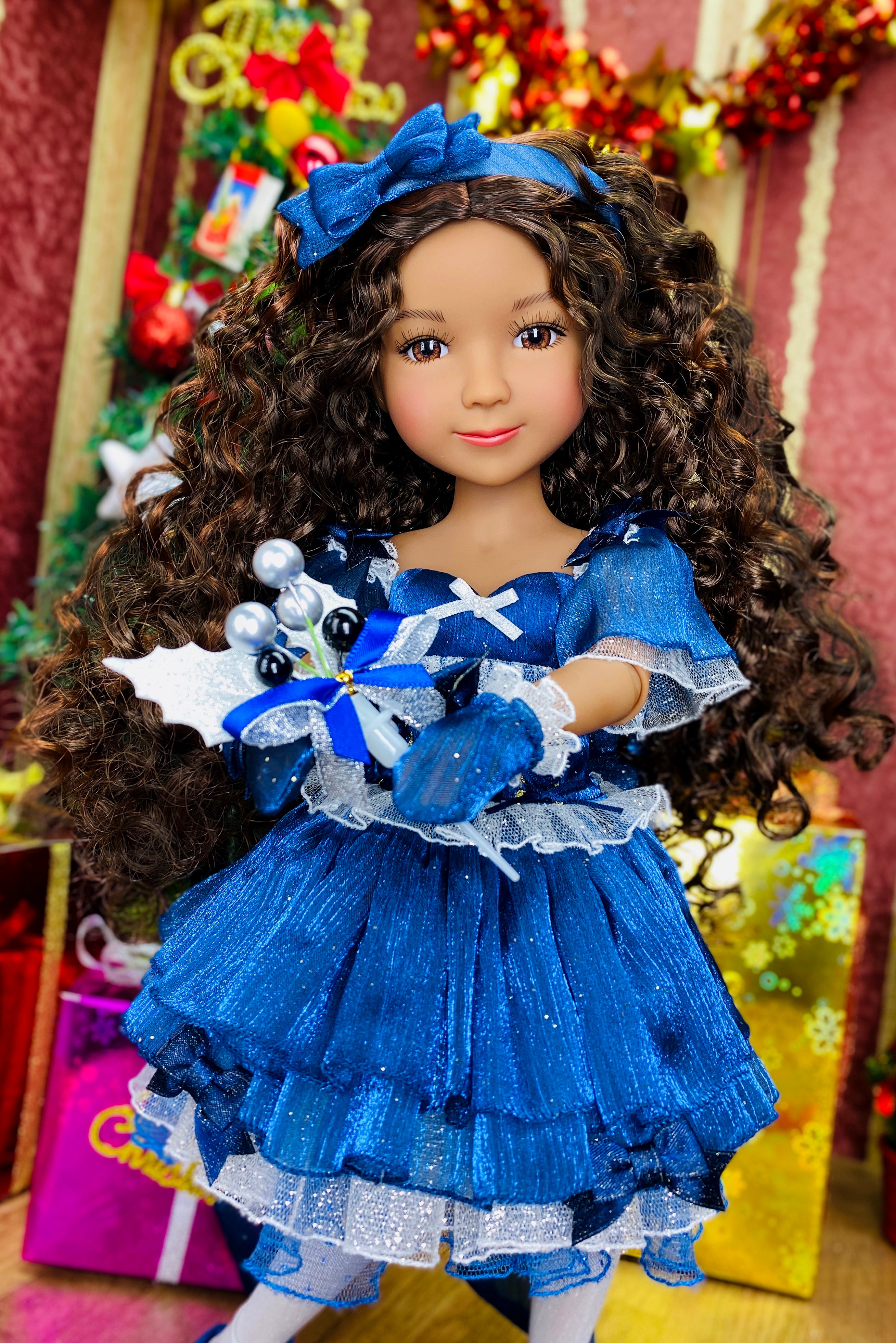 Doll in a blue dress with a festive background