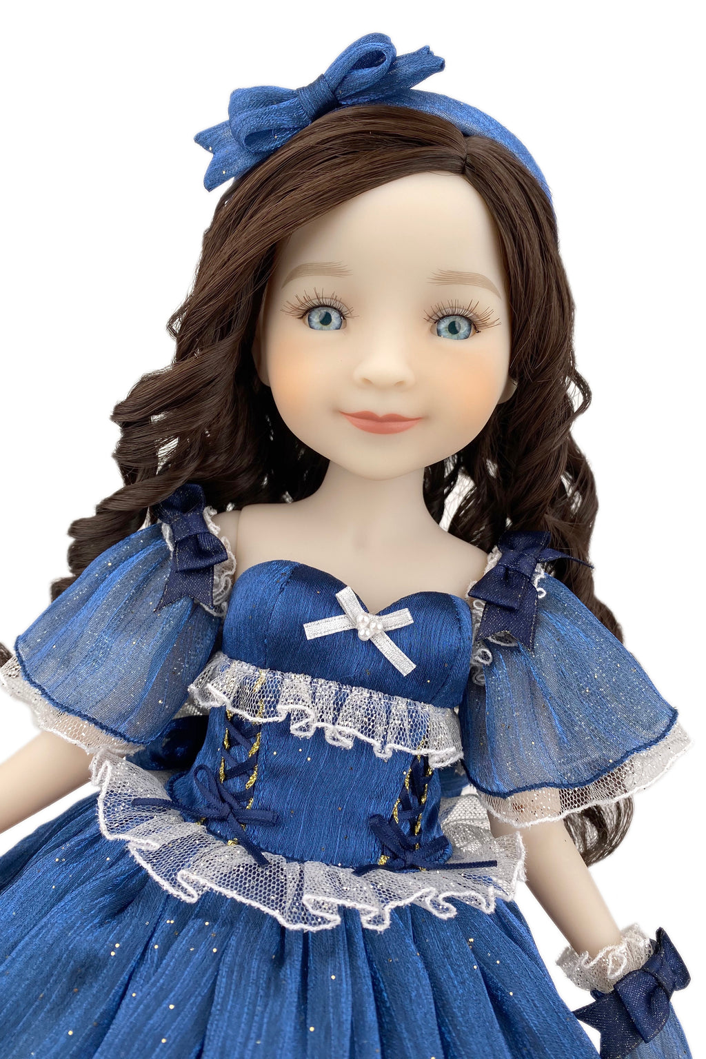Doll in a blue dress with a matching headband on a white background