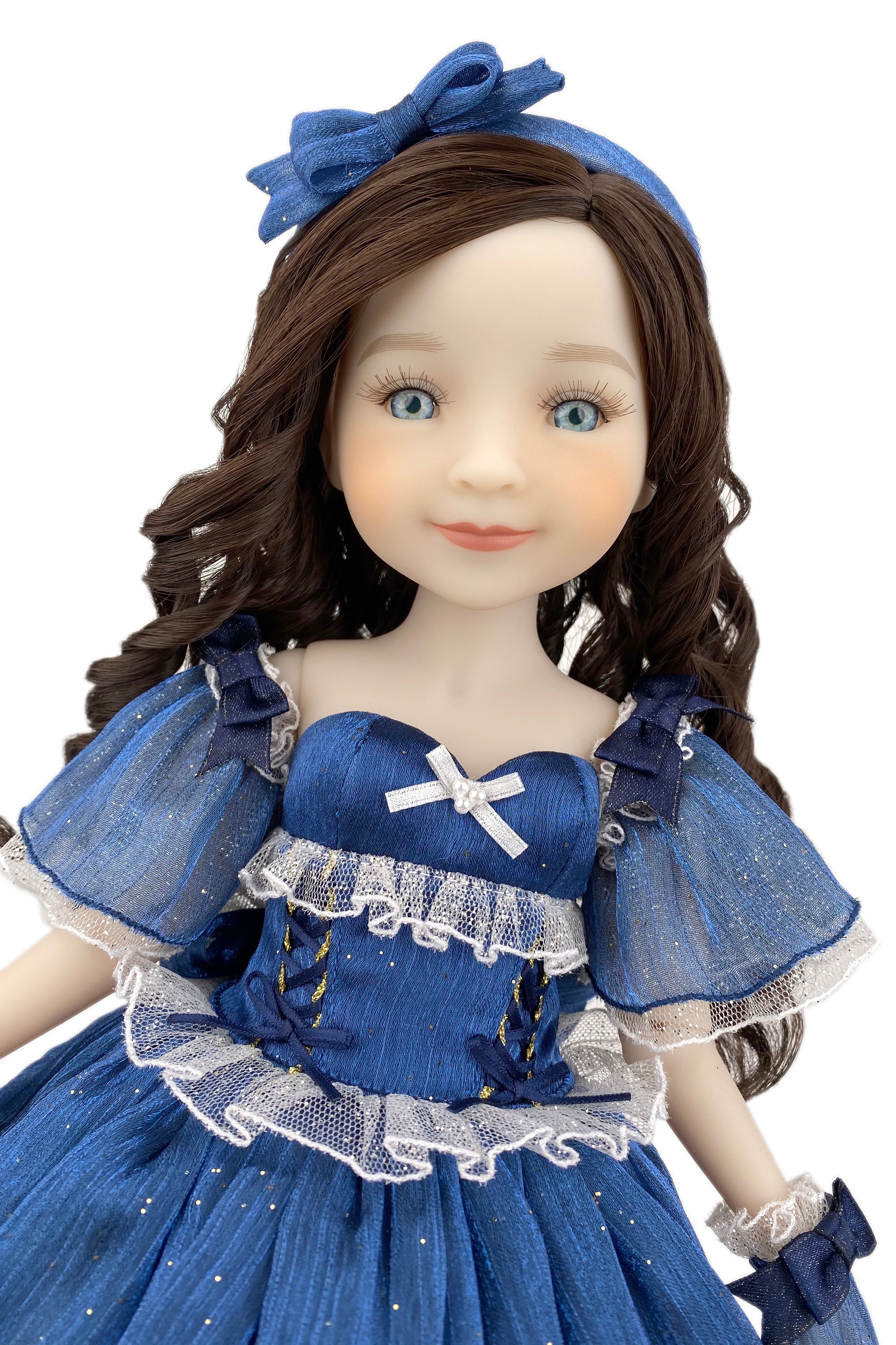 Doll in a blue dress with a matching headband on a white background
