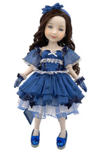 Doll wearing a blue dress with ruffles and a matching headband on a white background