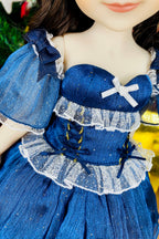 Close-up of a doll wearing a blue dress with white accents