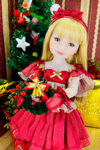 Doll in a red dress with a Christmas tree in the background