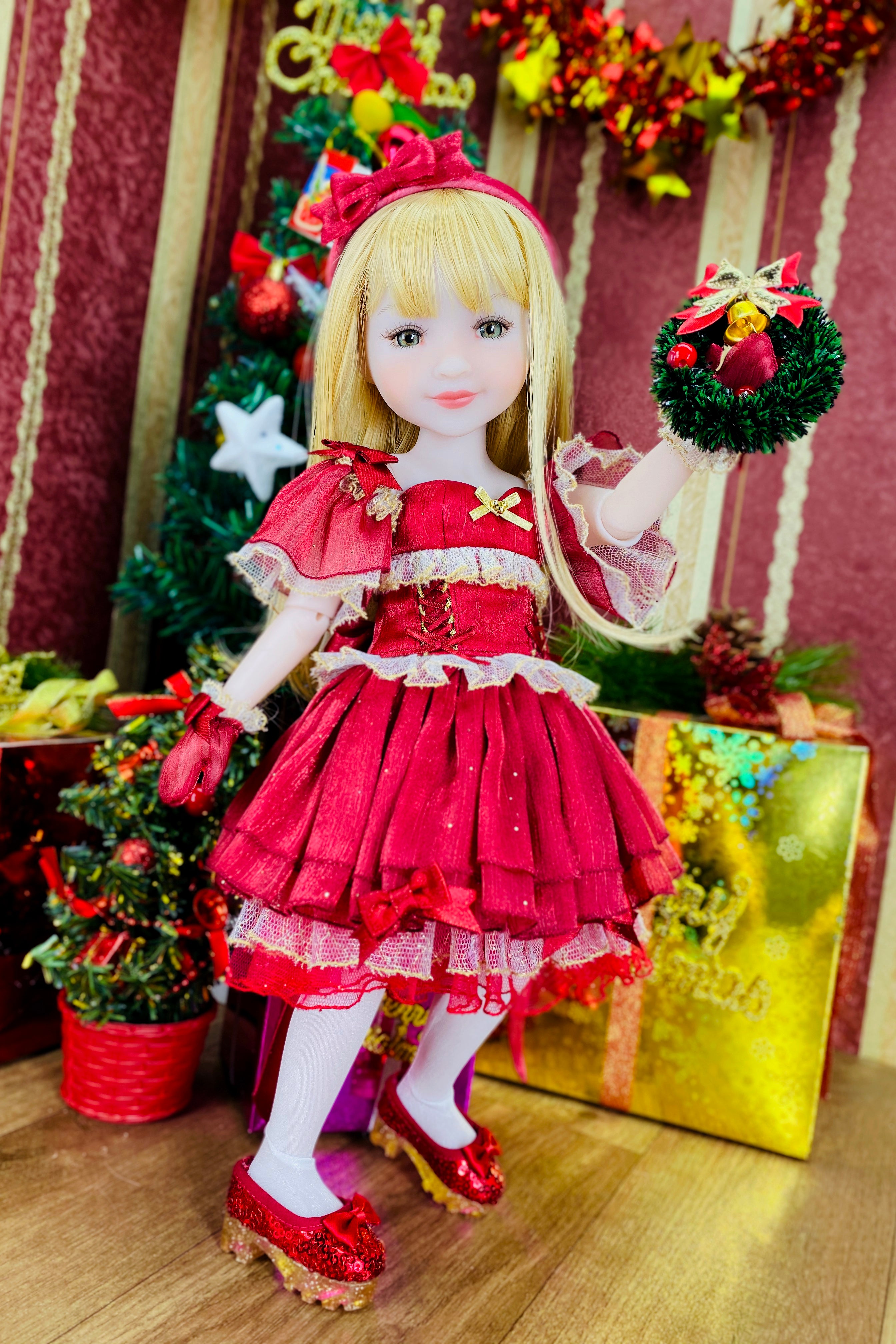 Doll in a red dress with Christmas decorations in the background