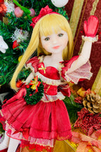Doll in a red Christmas outfit with a decorated tree in the background