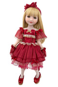 Doll in a red dress with a bow on a white background