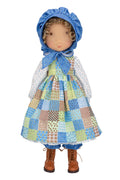 Holly Hobbie Doll wearing a patchwork dress and blue bonnet on a white background