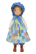 Holly Hobbie Doll wearing a patchwork dress and blue bonnet on a white background