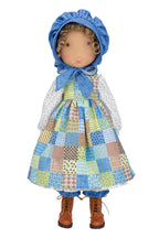 Holly Hobbie collectible doll wearing a patchwork dress and blue bonnet on a white background