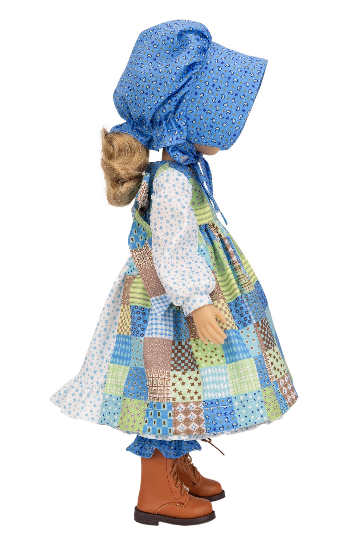 Holly Hobbie Doll wearing a blue bonnet, checkered dress, and brown boots on a white background
