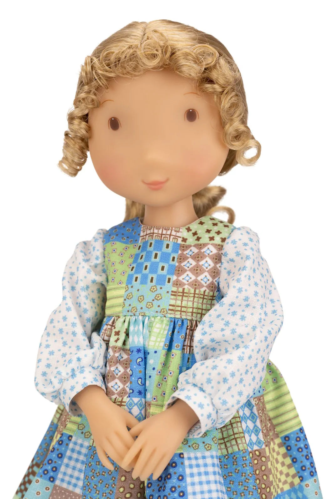 Holly Hobbie collectible doll wearing a colorful patchwork dress on a white background