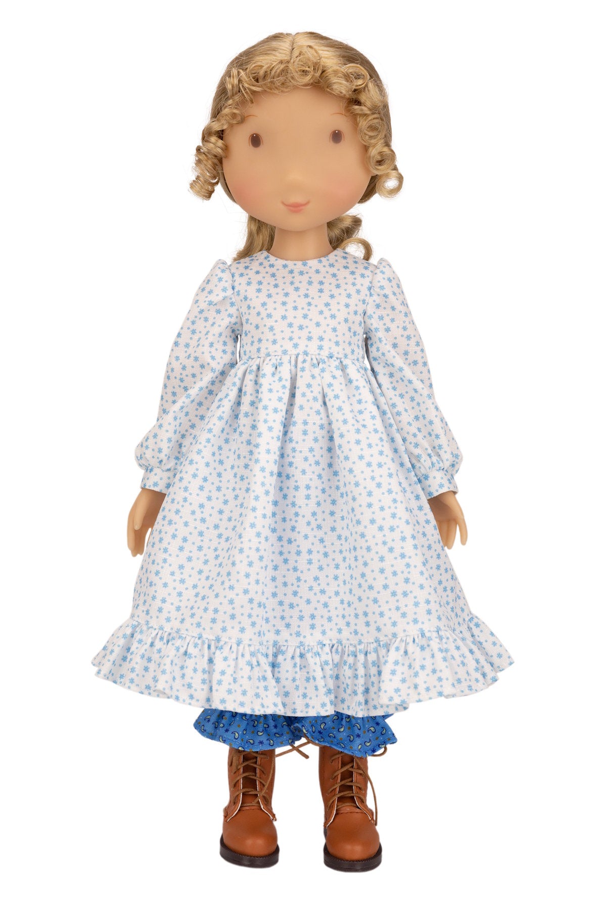 Holly Hobbie Doll wearing a blue floral dress with brown boots on a white background