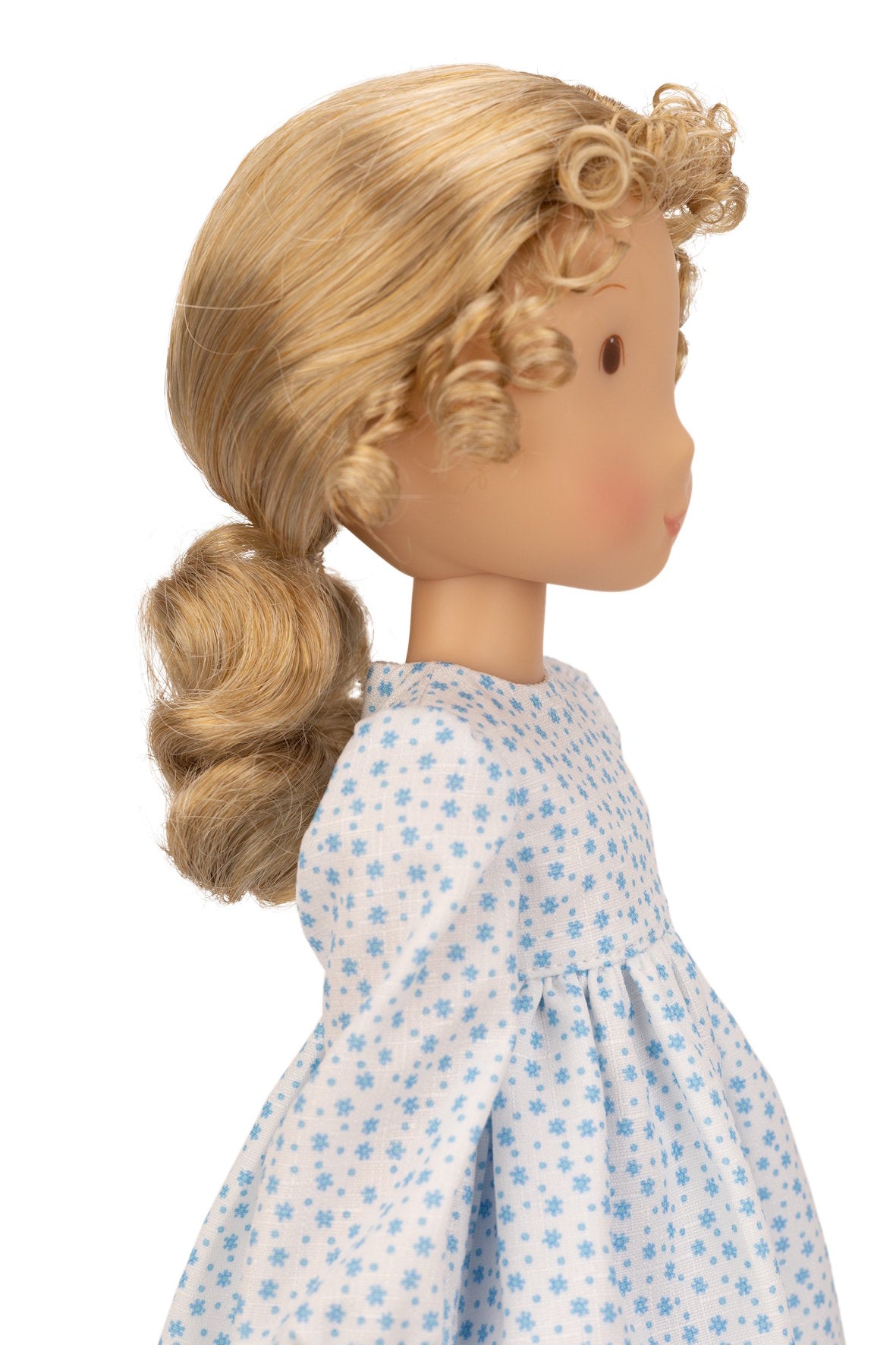 Holly Hobbie Doll with blonde hair styled in a side braid wearing a floral dress on a white background