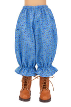 Blue patterned pants with brown boots on a white background