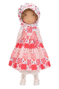 Holly Hobbie Doll wearing a patchwork dress with a floral hood on a white background