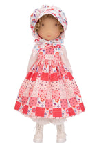 Holly Hobbie collectible doll wearing a floral dress with a hood on a white background