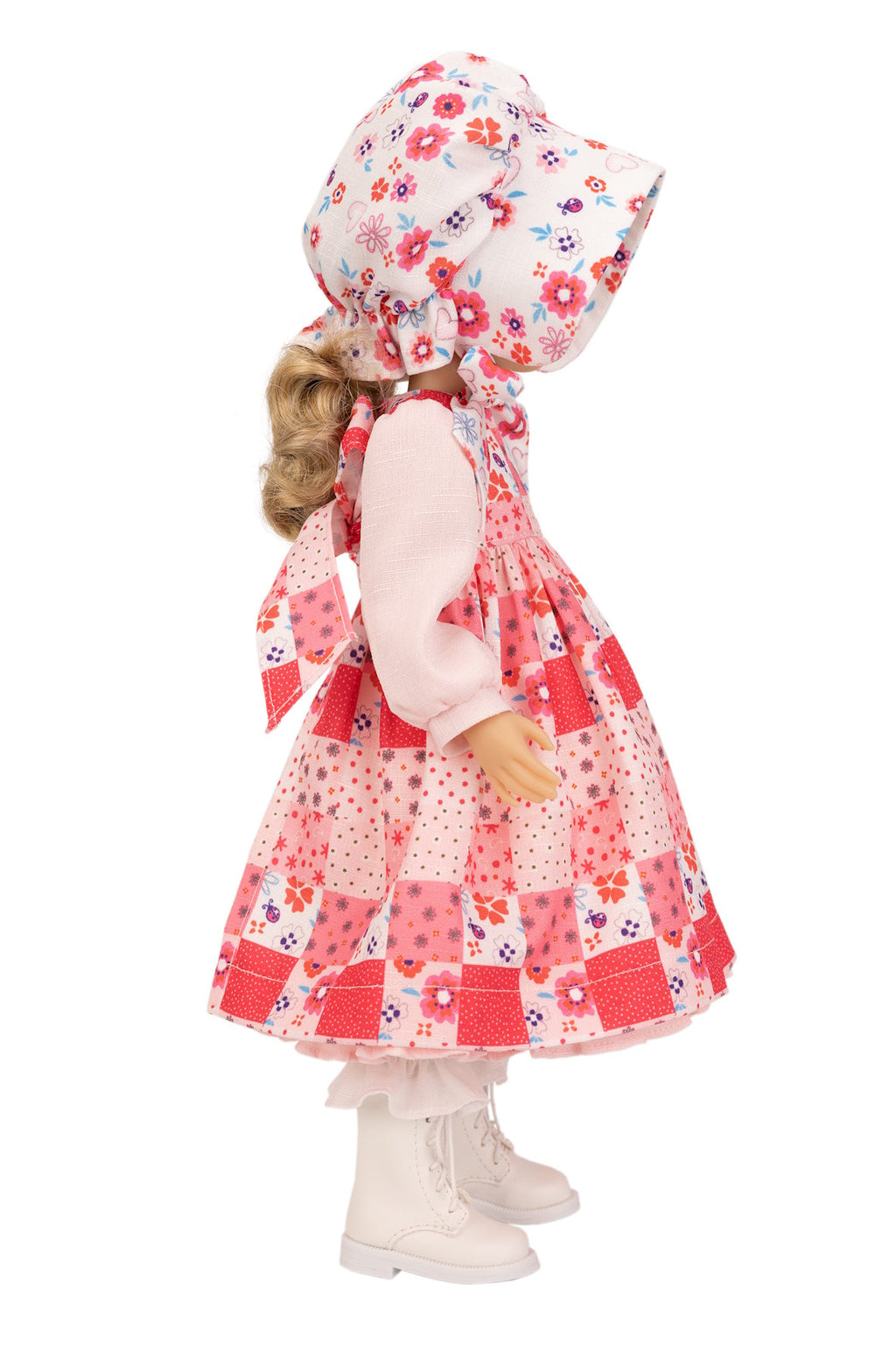 Holly Hobbie Doll wearing a floral dress and hat on a white background