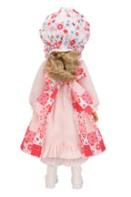 Holly Hobbie doll with floral hat and coat on a white background