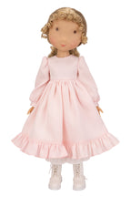Holly Hobbie Doll wearing a pink dress with long sleeves on a white background