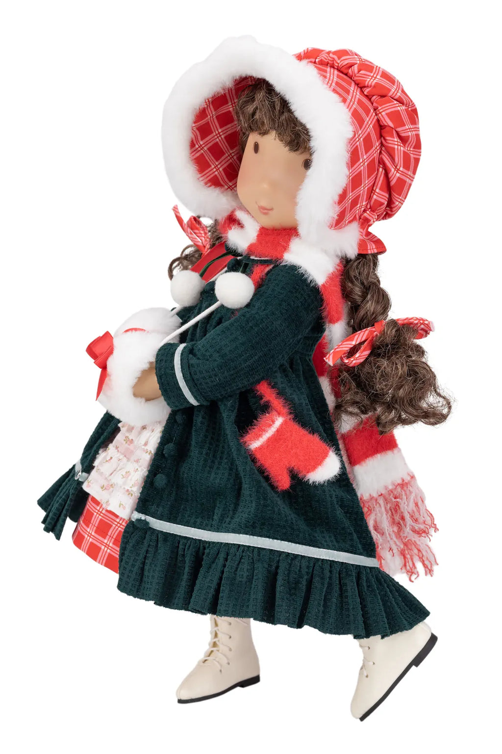 A Christmas-themed Holly Hobbie doll wearing a dark green dress, red and white plaid bonnet, matching scarf, and white boots, isolated on a white background.