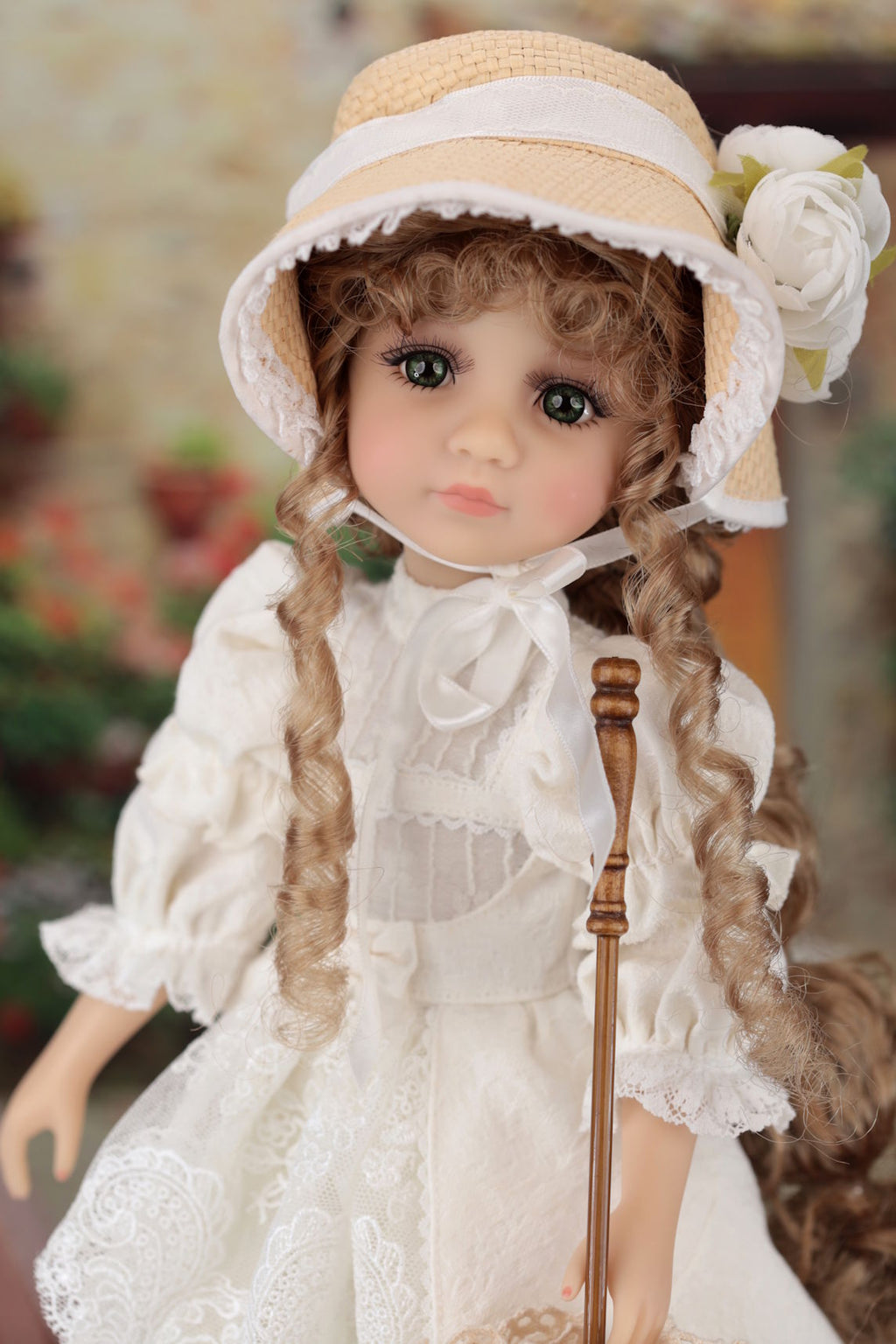 Doll in a white dress and hat with a blurred background