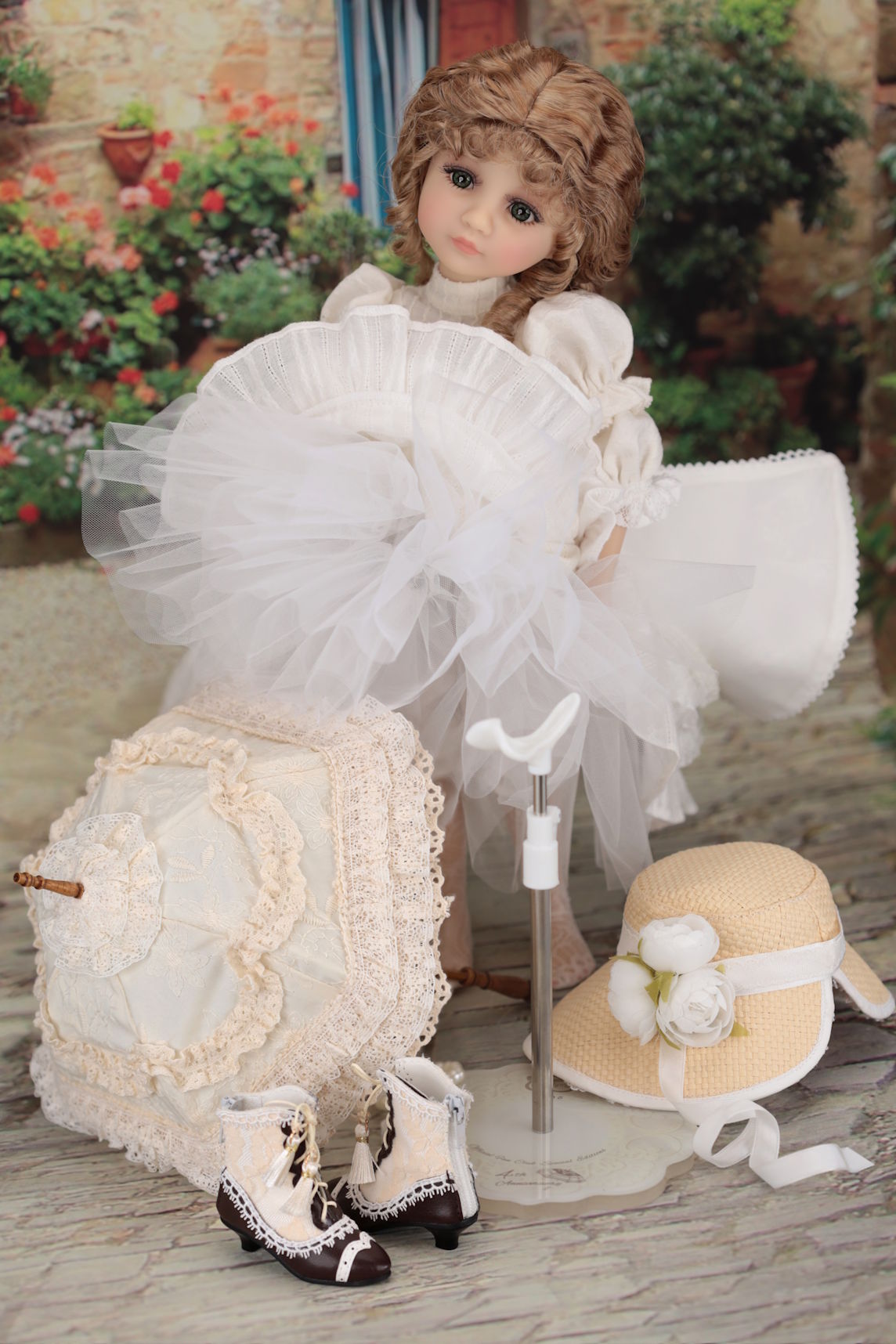 Photo showing all content of the doll set including unbrella, hat, shoes and doll stand.