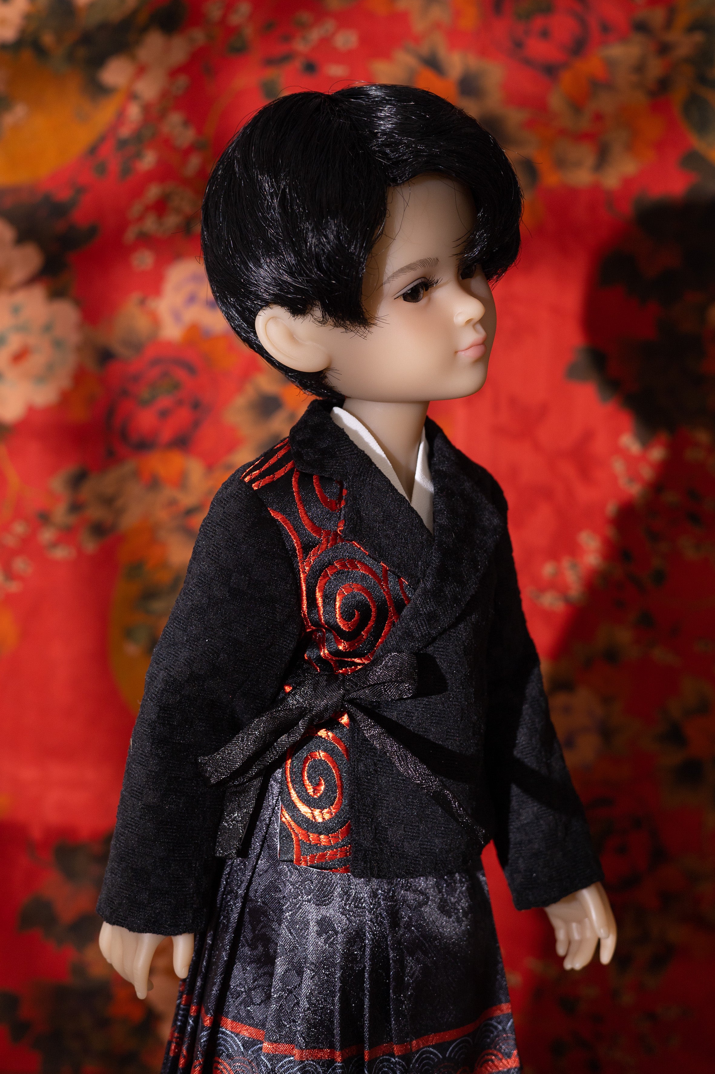 Doll wearing a traditional outfit with a floral background